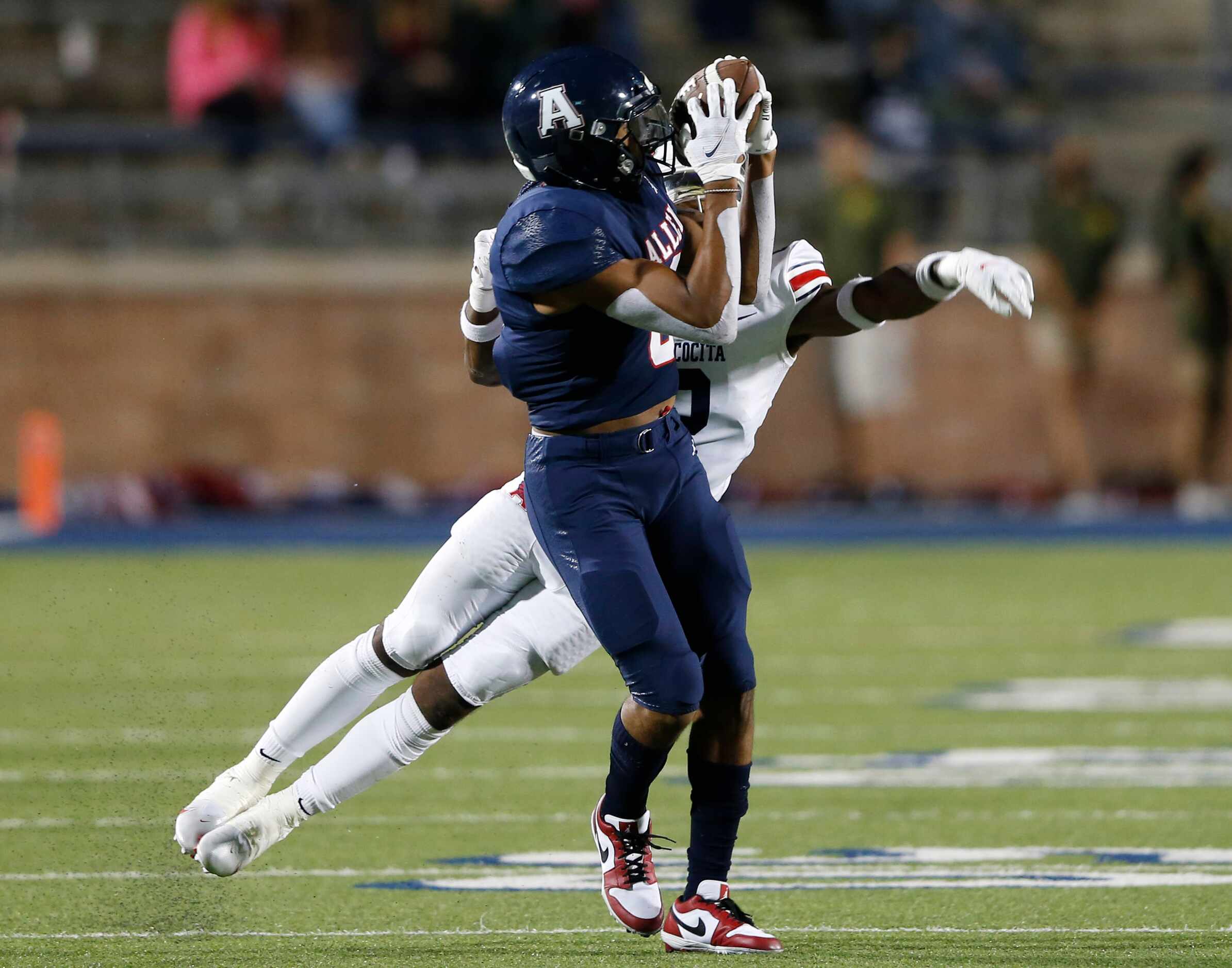 Allen's Blaine Green (8) catches a pass in front of Humble Atascocita's Caleb Burton (2)...