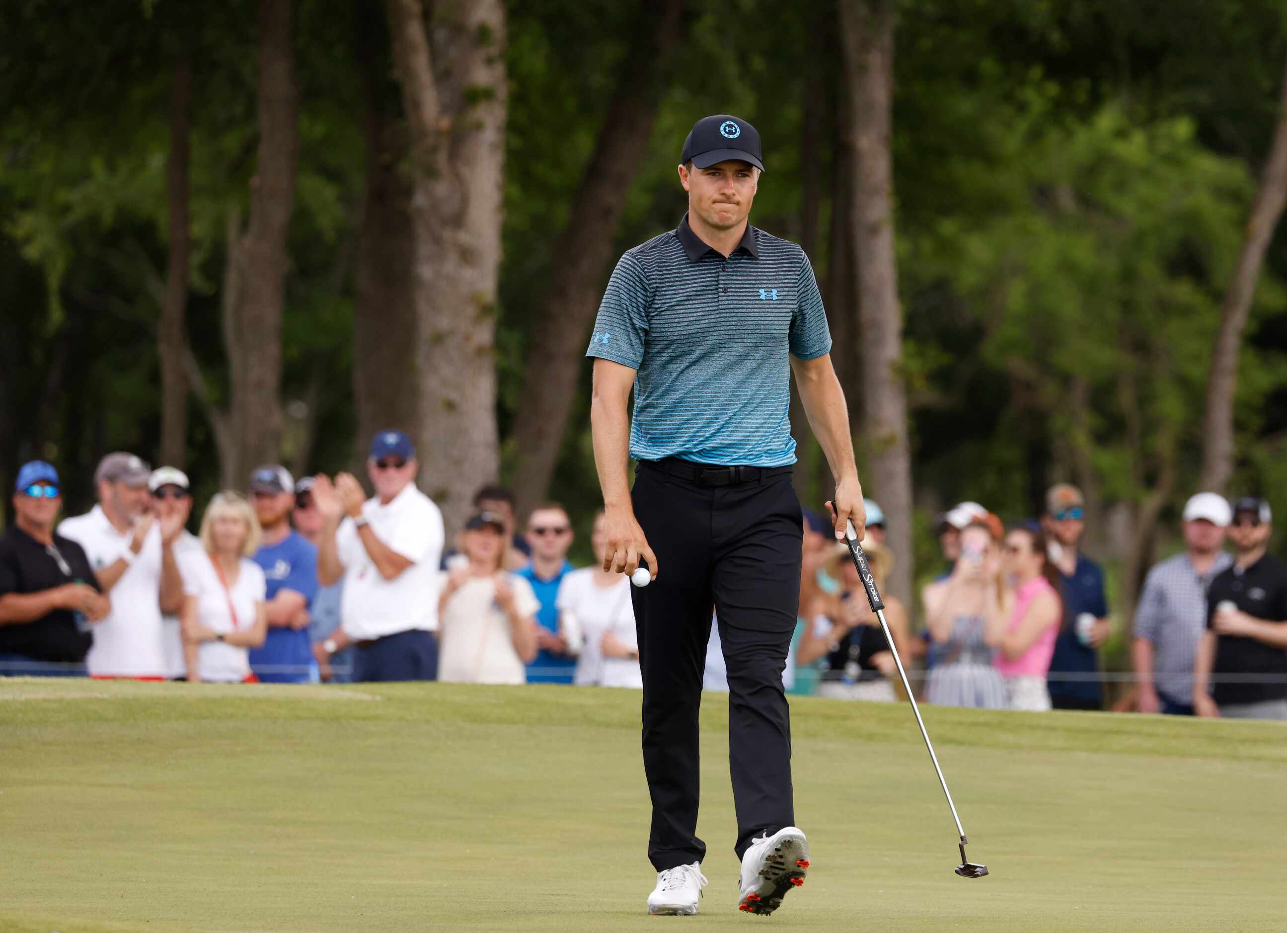 Jordan Spieth acknowledges the crowd after getting a birdie on the 14th hole during round 3...