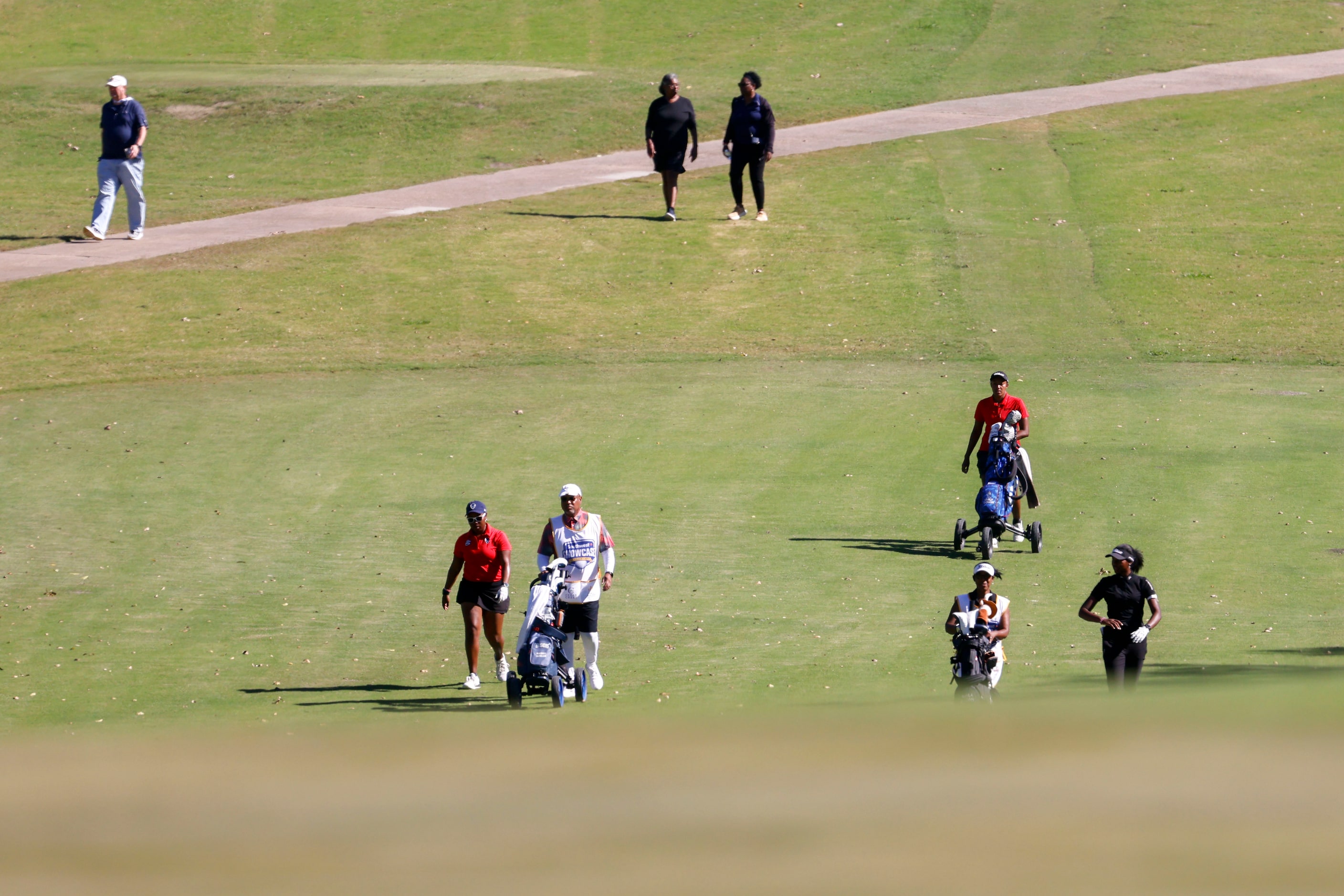 Golfers including Emily Odwin of SMU (back) make their way on the fourth fairway during the...