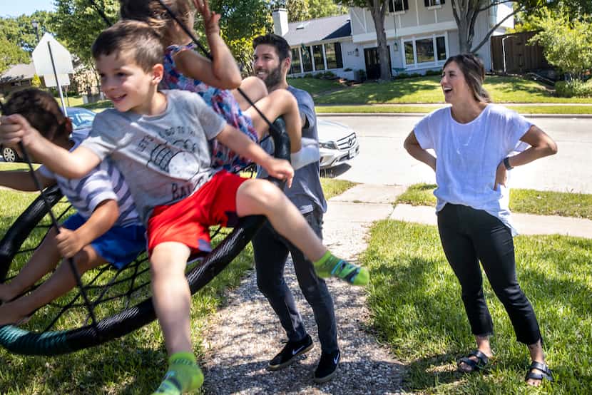Ryan and Taylor Hollingshead play with their children (from left), their 2-year-old foster...