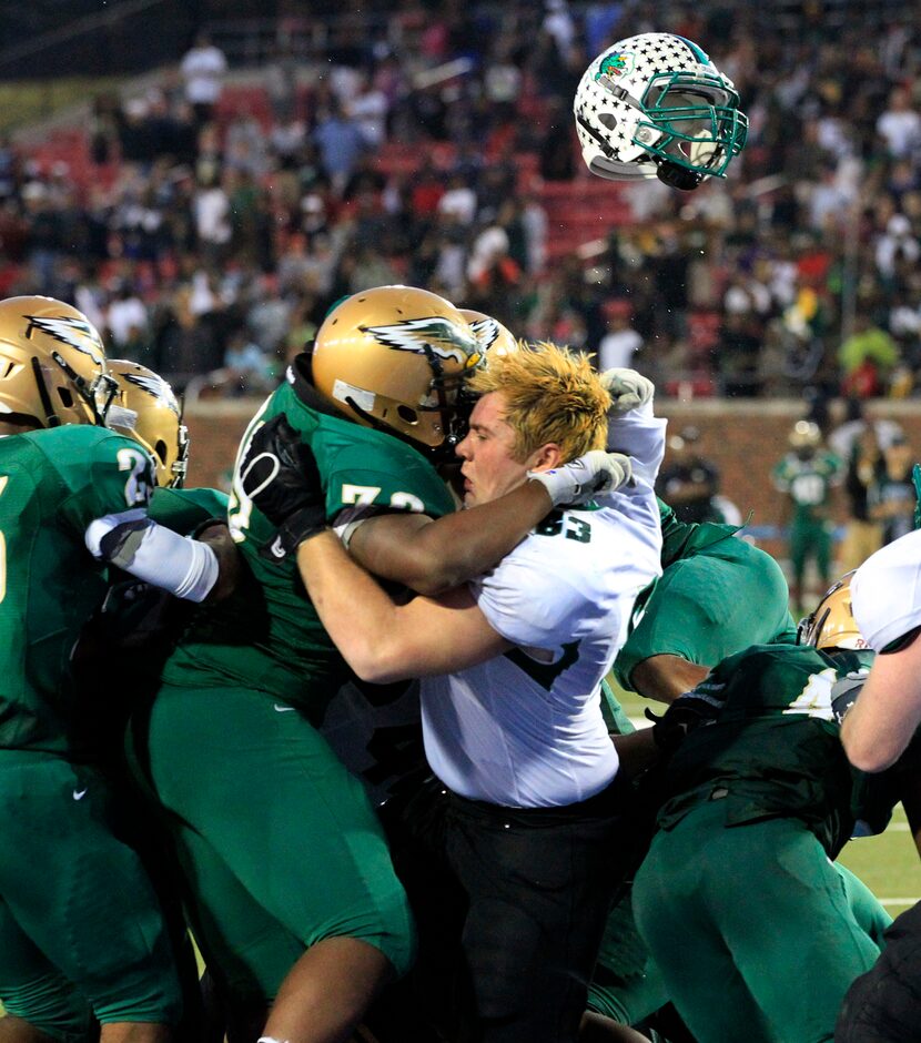 DeSoto's High's DB Shaquel Jackson (39) and Southlake High's Evan Brown (63) tangle (with...