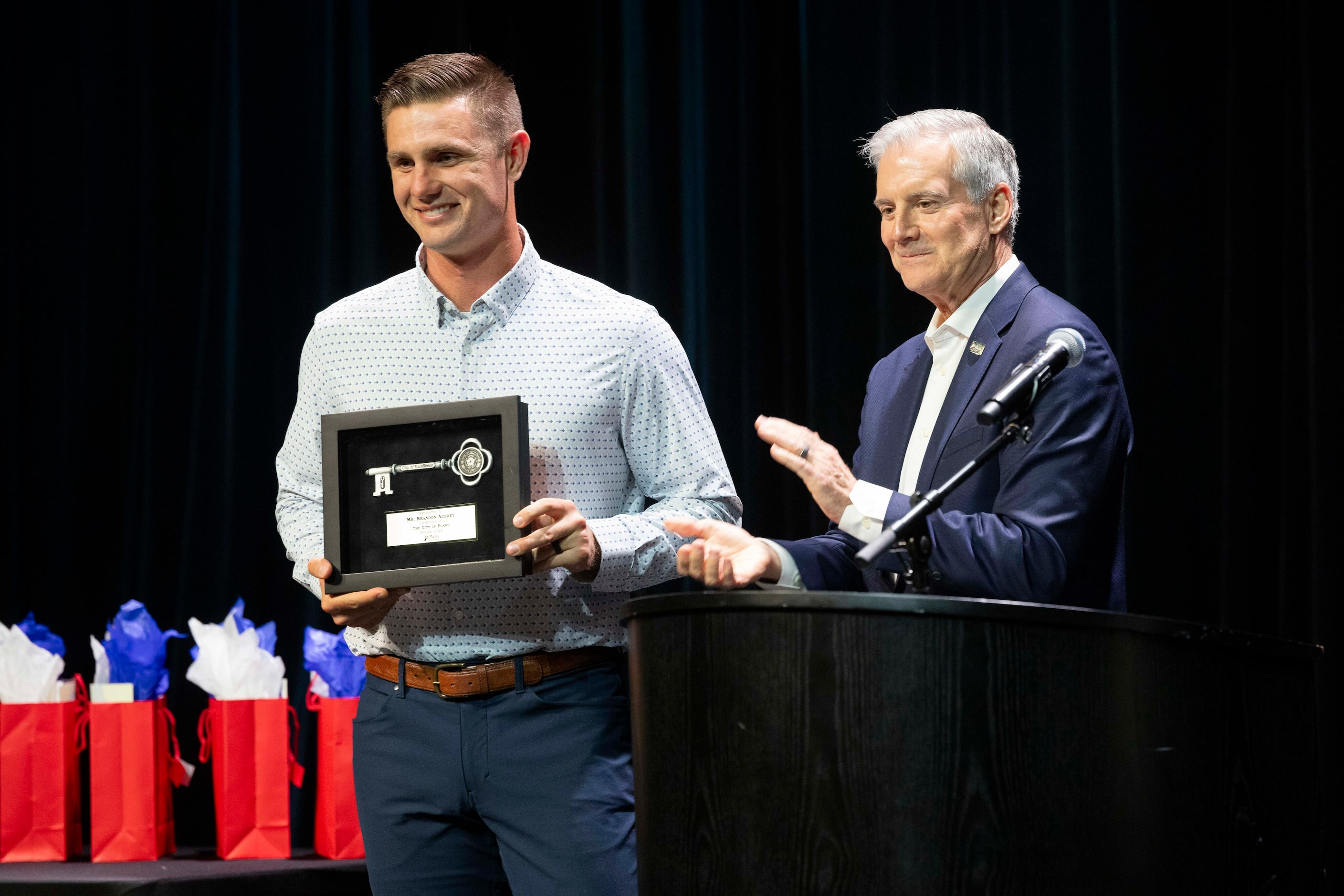 Plano native and Dallas Cowboys kicker Brandon Aubrey, left, is presented the key to the...