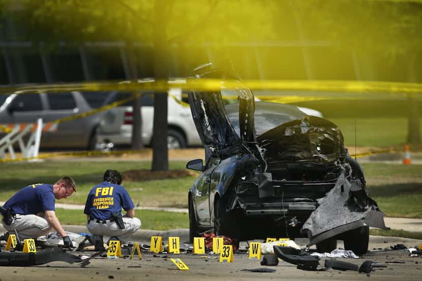 FBI agents document the scene after two gunmen opened fire on an unarmed Garland ISD...
