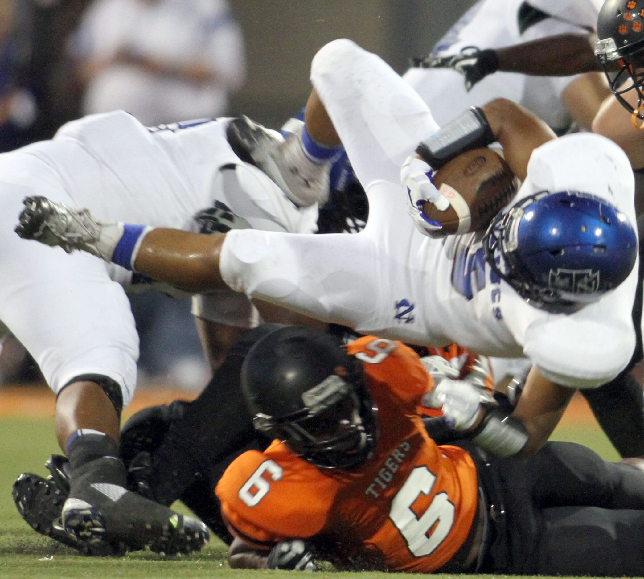 Fort Worth Nolan running back Eric Alvarez (5) is upended by Lancaster defensive back Rickey...