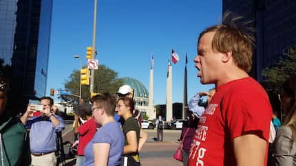 Charles Hermes (right) of Grand Prairie screams "No Trump!" as part of a chant delivered by...