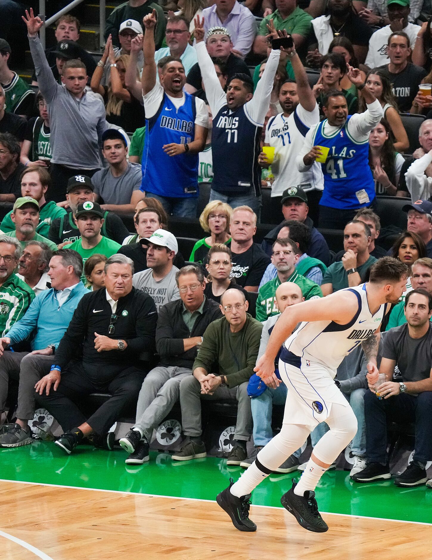 Dallas Mavericks fans celebrates a 3-pointer by guard Luka Doncic during the first half in...