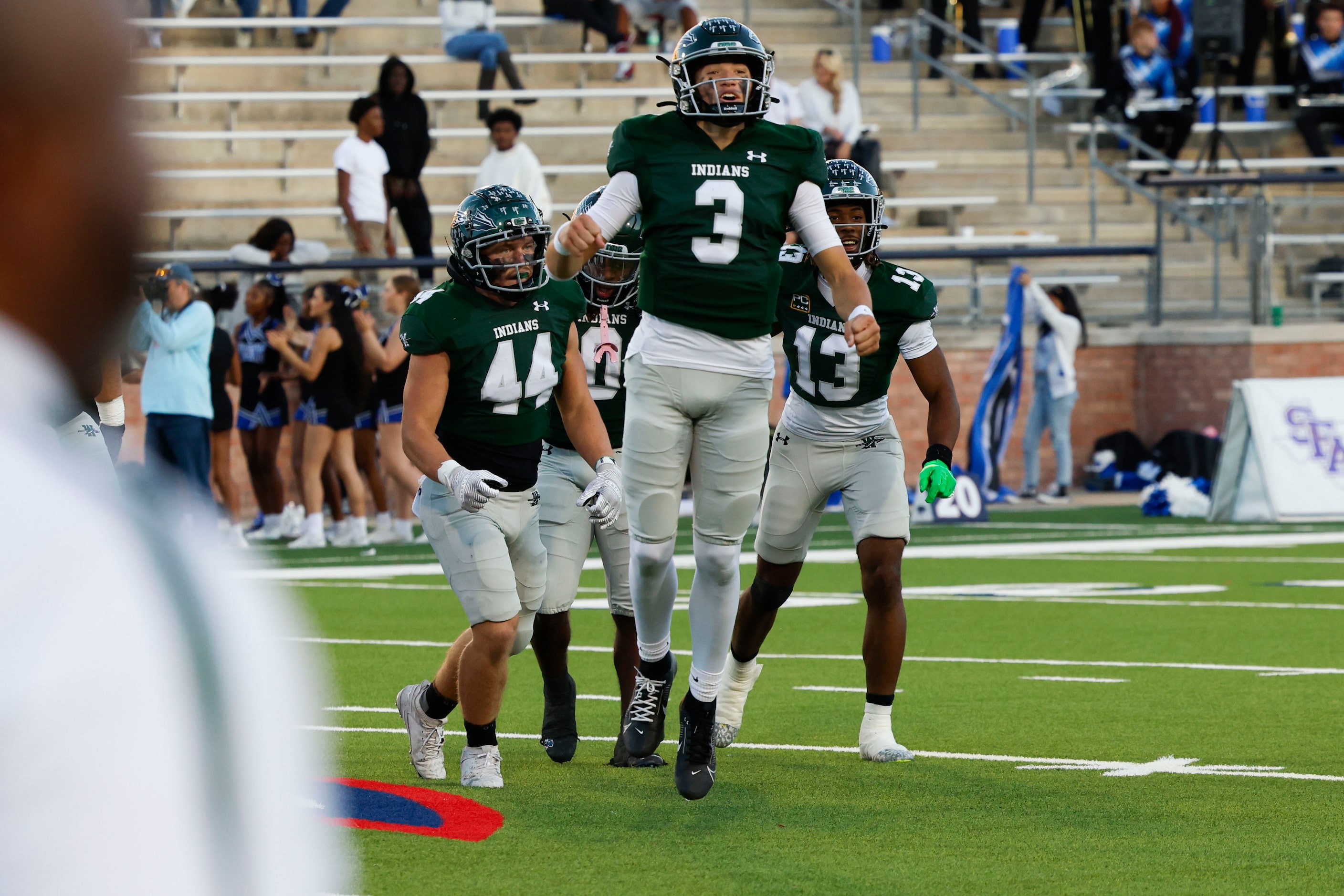 Waxahachie high players including Jerry Meyer III celebrate following their win against...