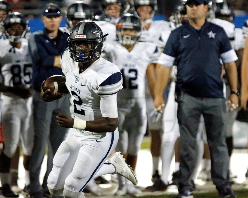 Lone Star High School quarterback MJ Rivers (2) keeps the football for a gain up the side...