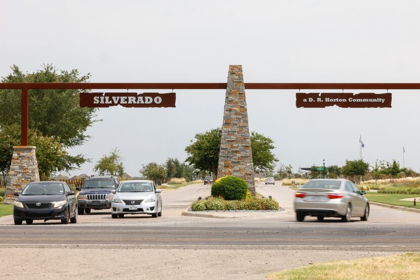 Vehicles pass through the front entrance of the Silverado master-planned community in Aubrey. 
