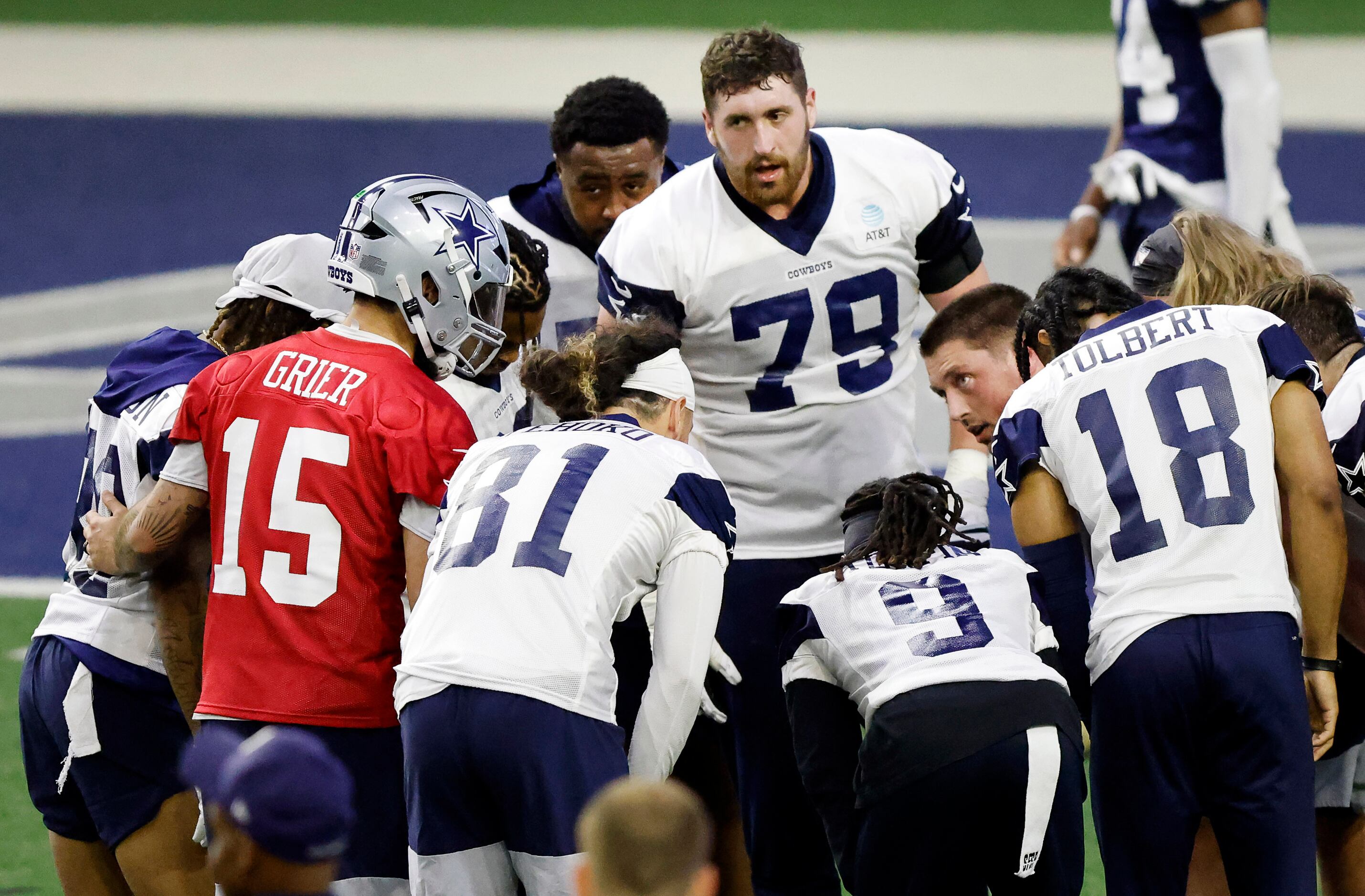 Dallas Cowboys offensive tackle Matt Waletzko (79) leans in to hear the play call from...