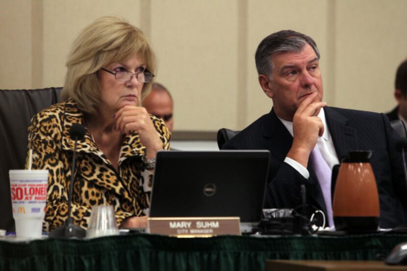 Dallas City Manager Mary Suhm, who announced her resignation earlier this year, listens to a...