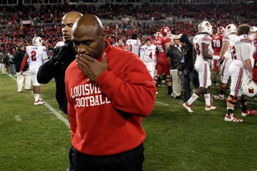 Louisville coach Charlie Strong walks off the field after Louisville's 31-24 loss to North...
