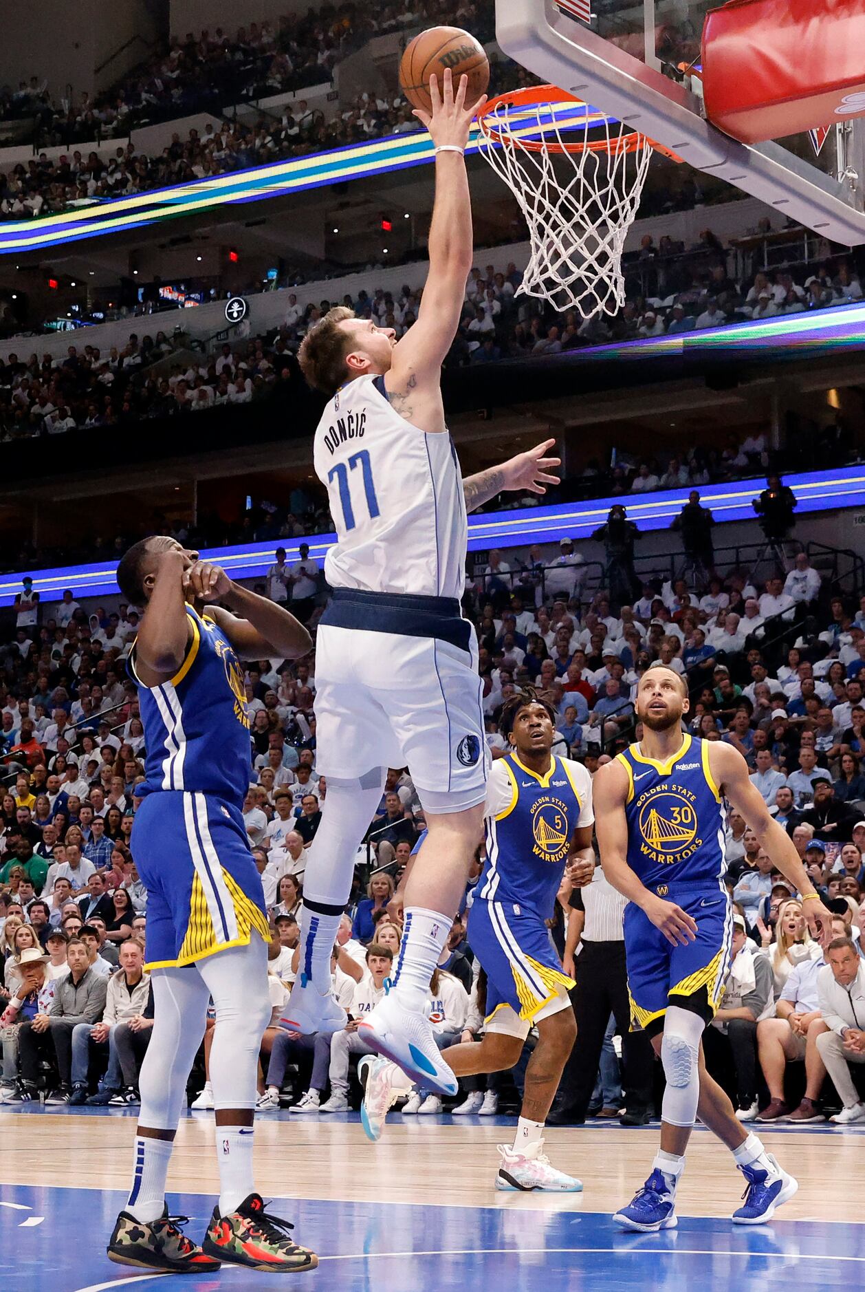 Dallas Mavericks guard Luka Doncic (77) puts up a an easy basket against Golden State...