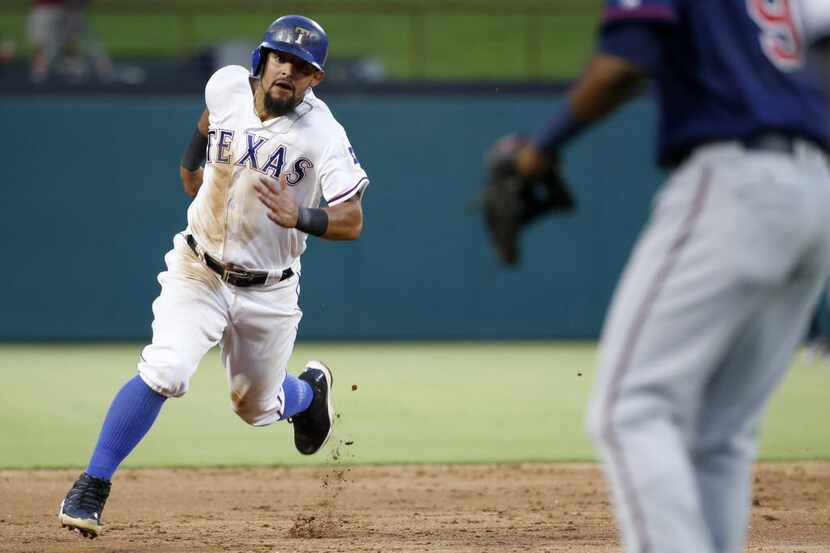 Texas Rangers second baseman Rougned Odor (12) runs to third base on his way to scoring in...