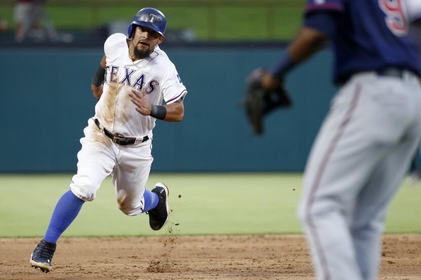 Texas Rangers second baseman Rougned Odor (12) runs to third base on his way to scoring in...