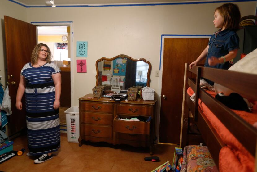 Angela Cook talks to her daughter Molly Cook, 3, at her home in Mineral Wells. Cook has two...
