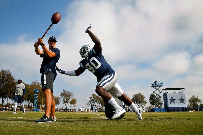 Dallas Cowboys defensive end Demarcus Lawrence (90) races in a circle to knock down the...