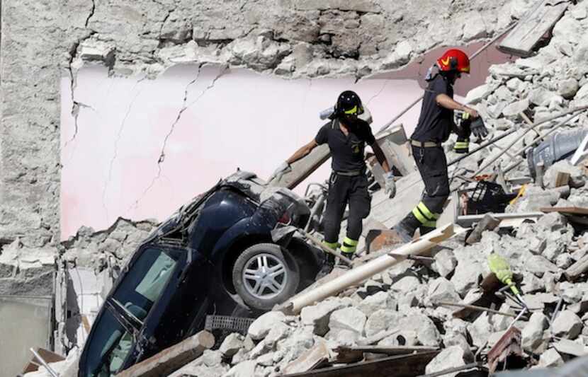 Rescatistas buscan sobrevivientes entre las casas destruidas en Pescara del Tronto, Italia.