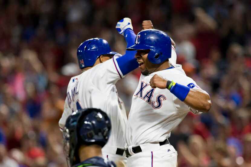 Texas Rangers left fielder Carlos Gomez (14) and teammate Elvis Andrus (1) celebrate Gomez's...