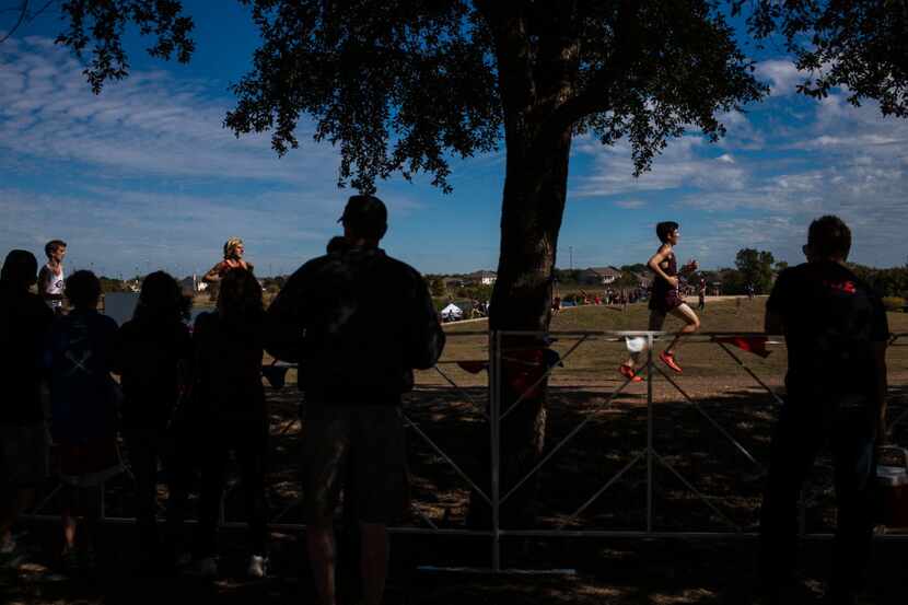 Fans cheer on runners during the Boys 5A race at the University Interscholastic League's...