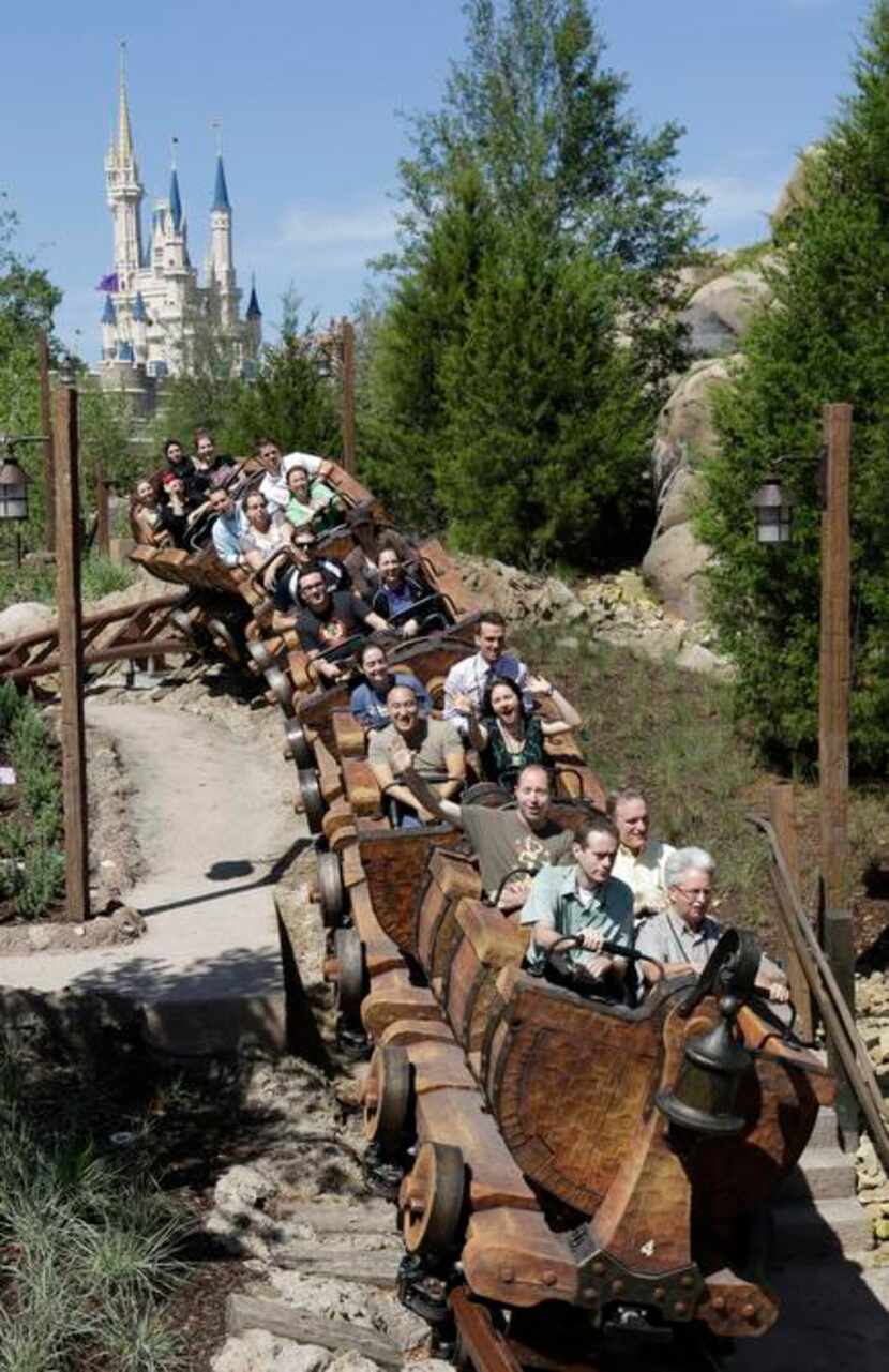 
The new Seven Dwarfs Mine Train roller coaster in Disney World plunges through a...