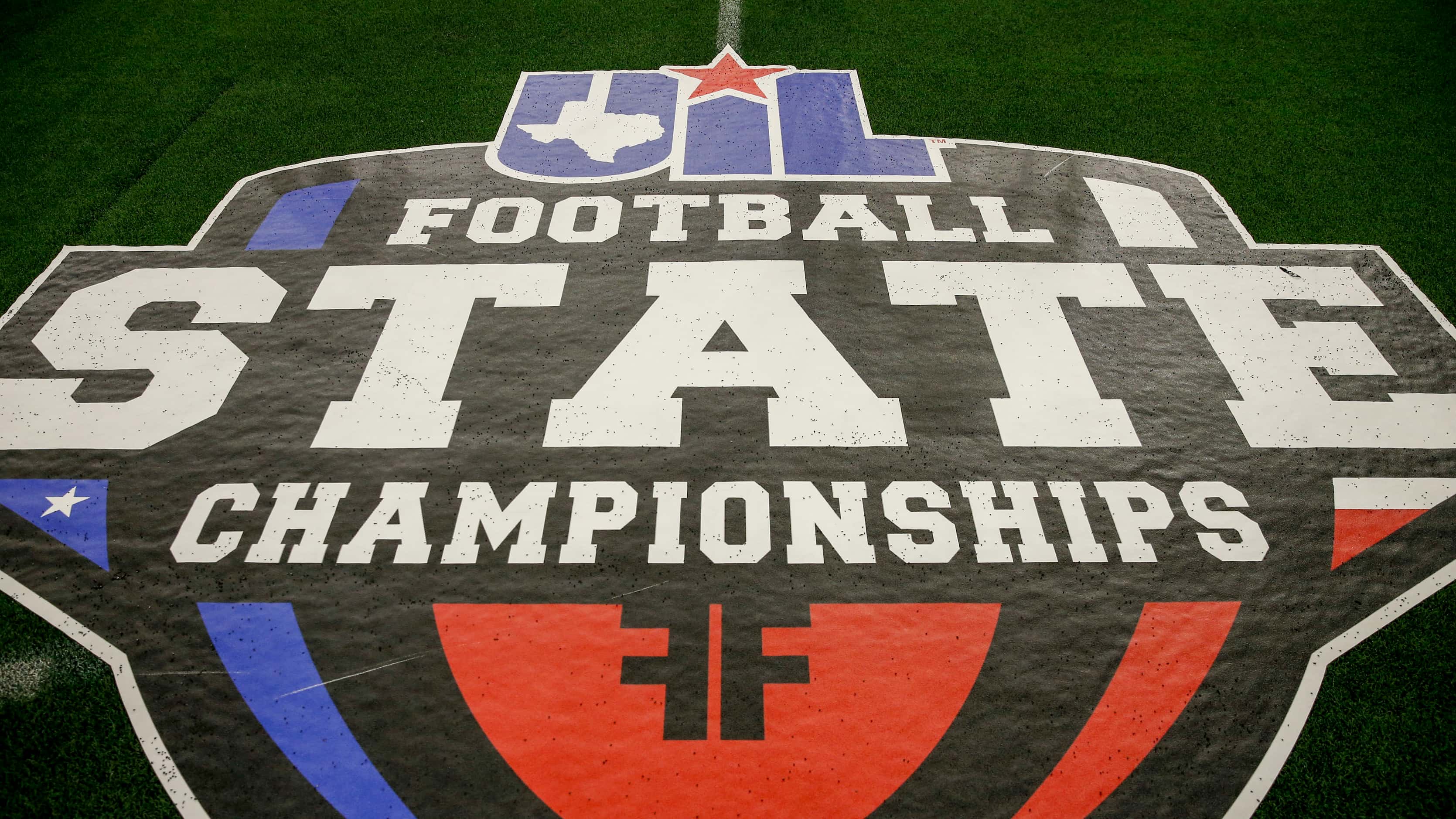 A University Interscholastic League state championship logo rests on the sideline during the...