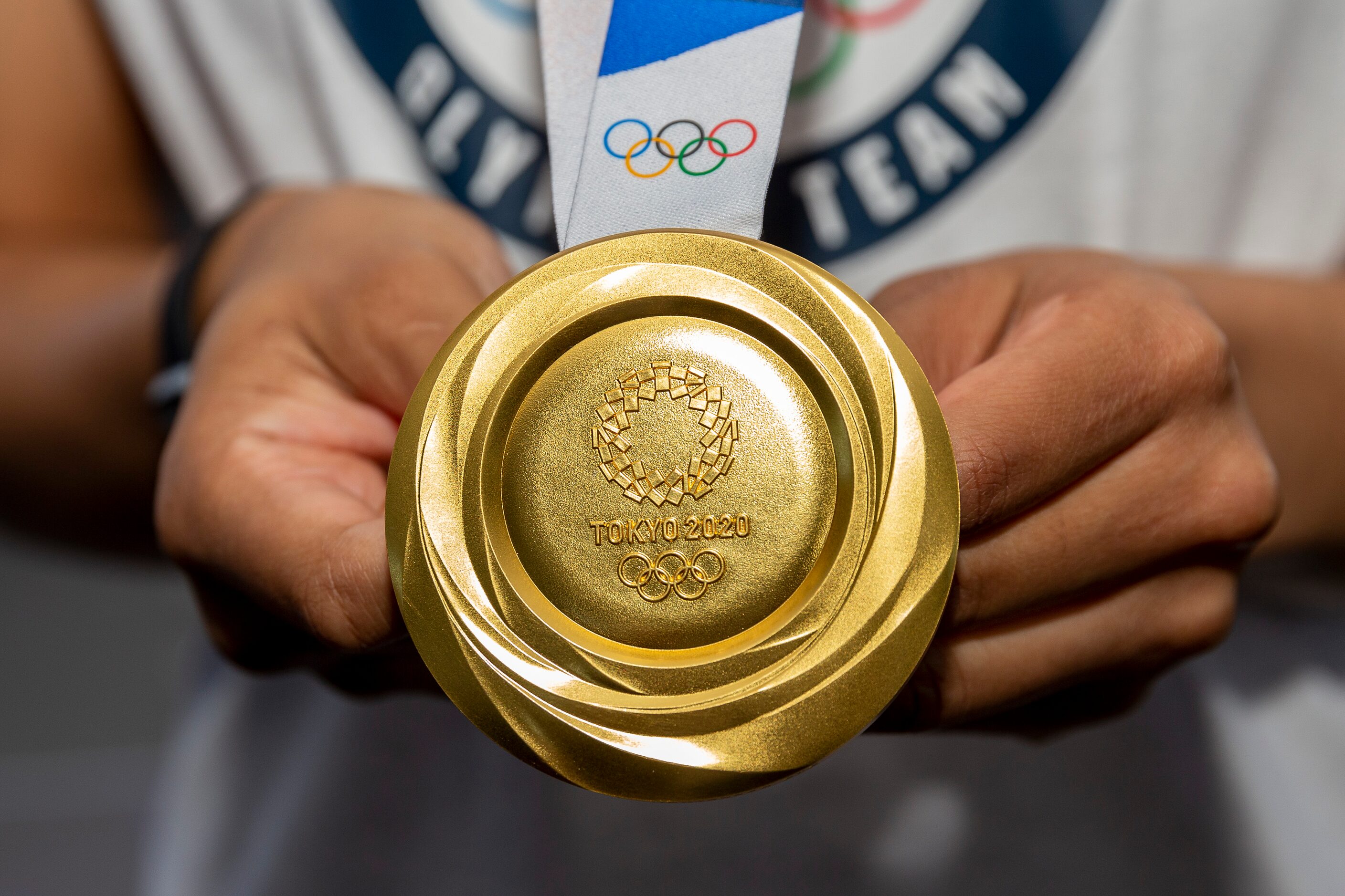 Allisha Gray, Olympic gold medalist and Dallas Wings guard, displays her gold medal during a...