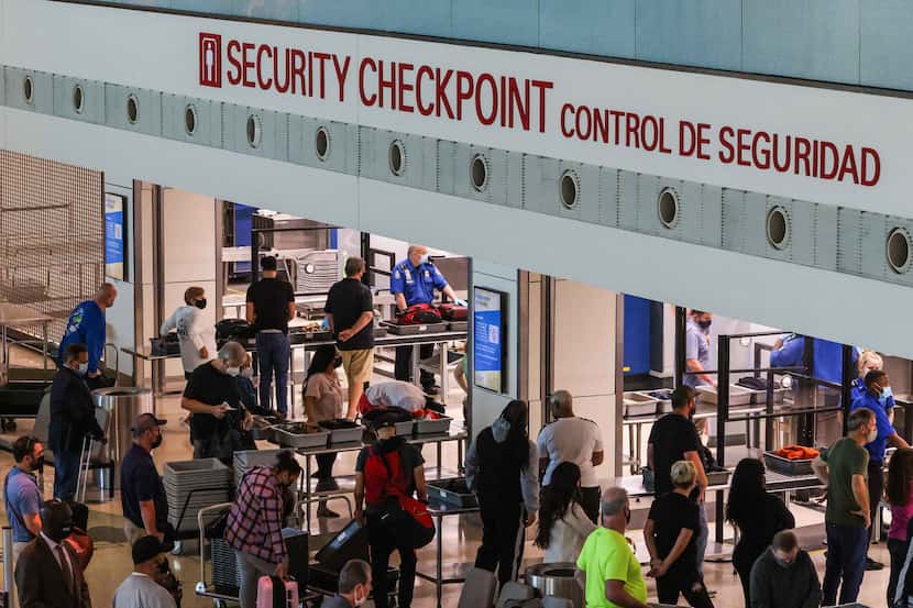 Travelers go through security checkpoint at the Dallas Love Field airport in Dallas....