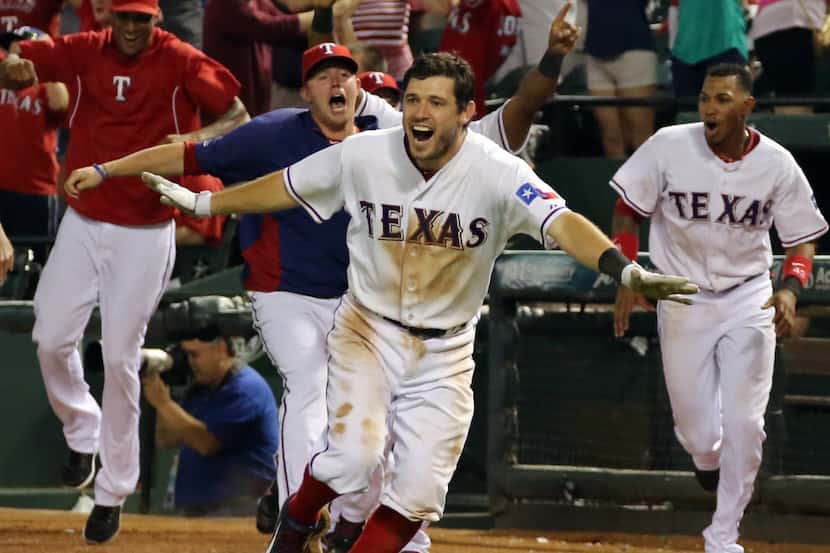 Texas second baseman Ian Kinsler heads to home plate to celebrate the Rangers' second of...