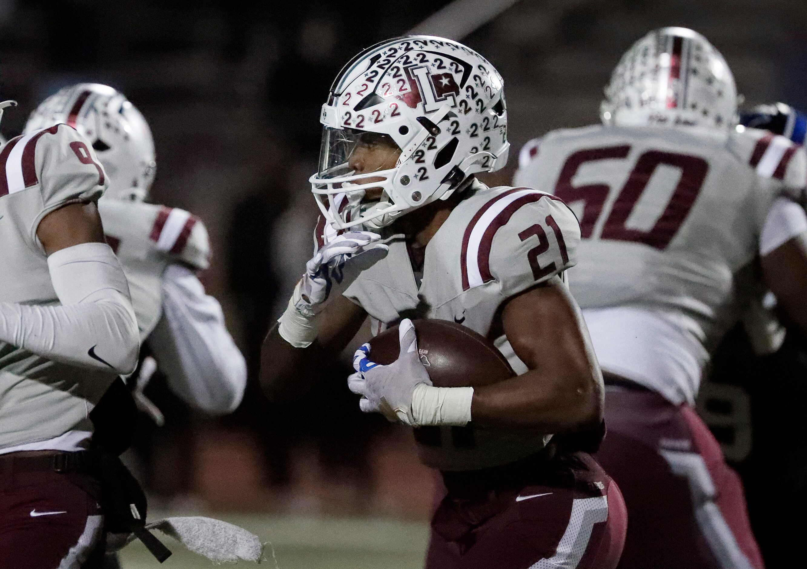 Lewisville High School running back Viron Ellison (21) runs through traffic during the first...