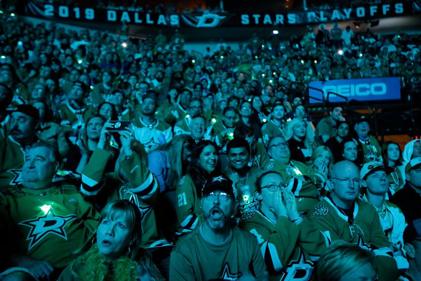 Dallas Stars fans watch a pregame video before they face the St. Louis Blues at the American...