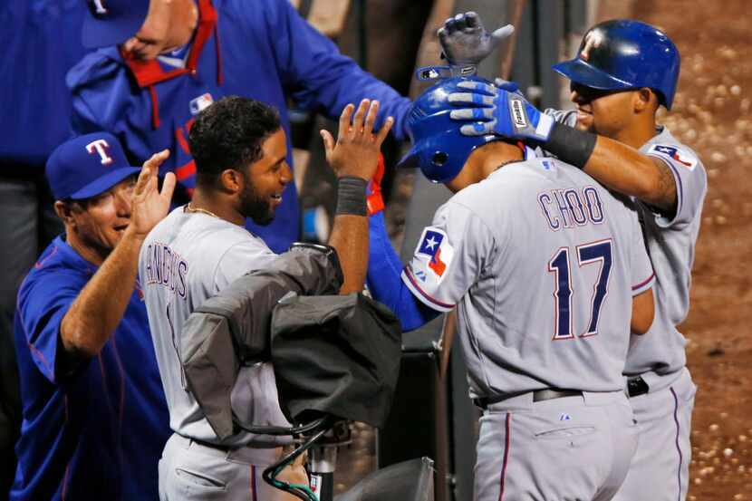 Texas Rangers' Shin-Soo Choo (17) is congratulated by, from left, manager Jeff Banister,...