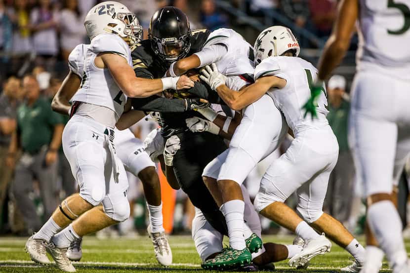 Plano East wide receiver Jaelen Anderson (16) get stopped by the Prosper defense as he...