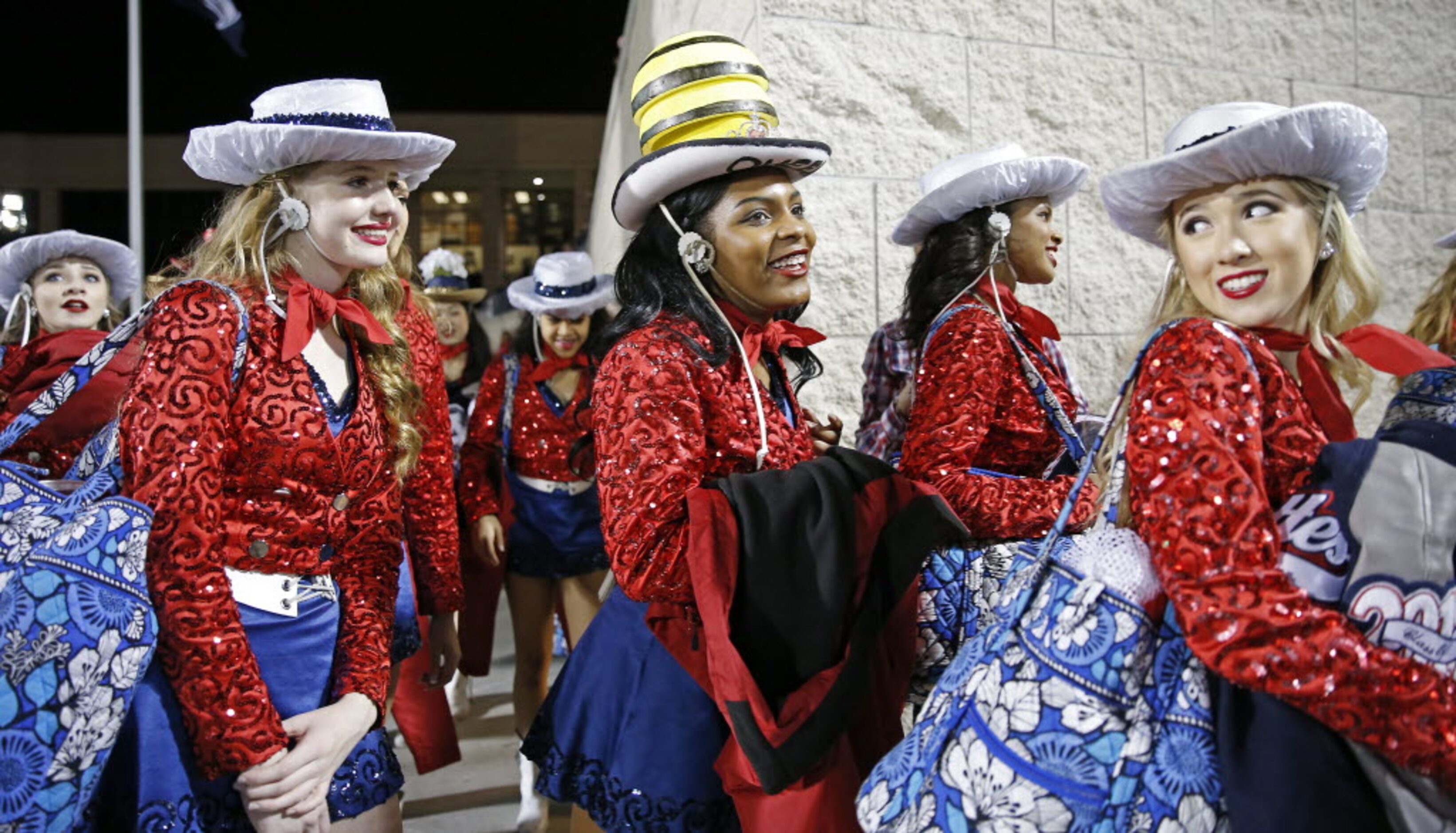 Members of the Allen High School's Tallenettes walk in to the Eagle Stadium prior to the...