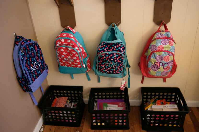 Backpacks and school work are organized for Angela Cook's children and foster children at...