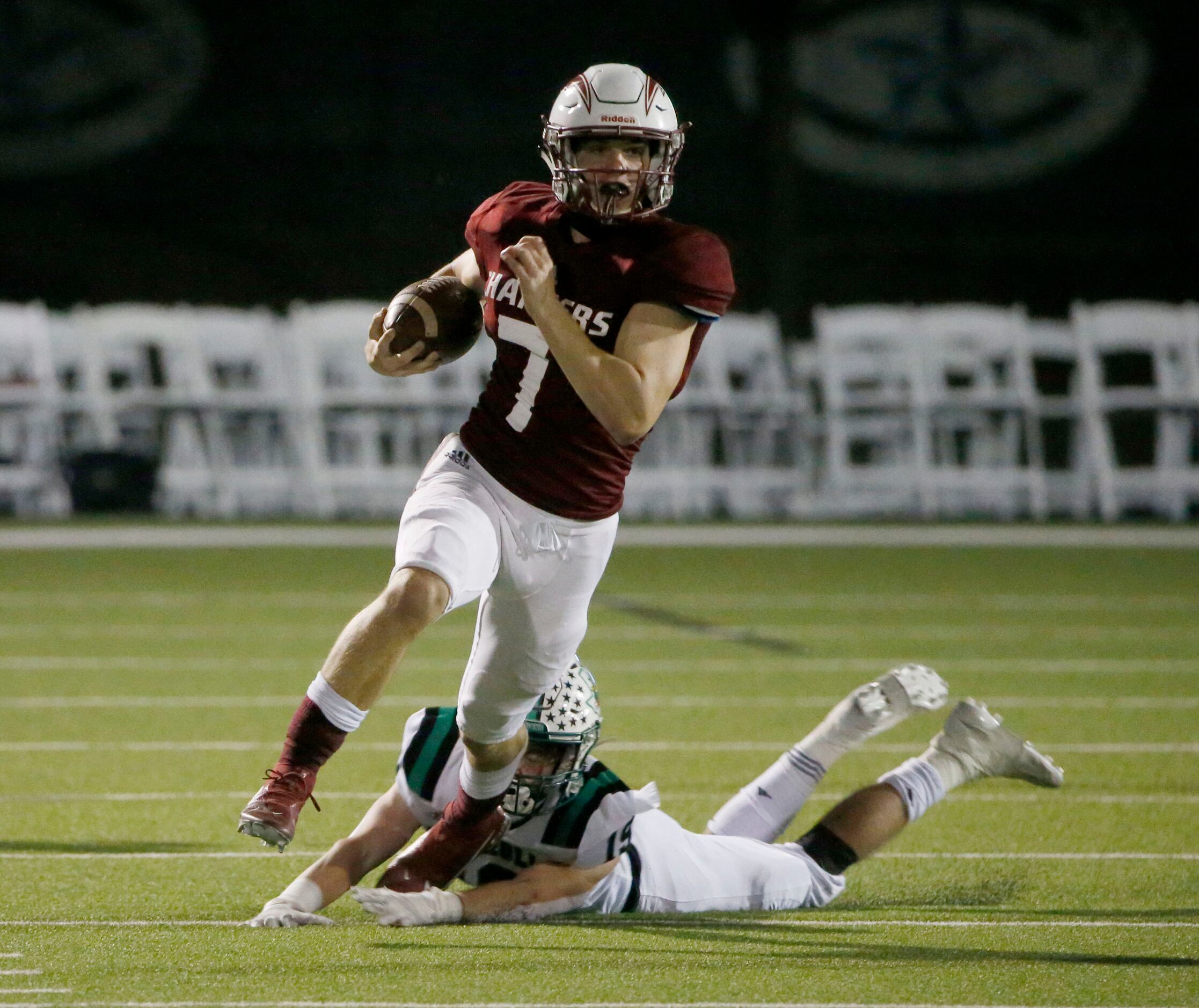 Keller Central quarterback Landon Walker (7) runs from an attempted tackle by Southlake’s...
