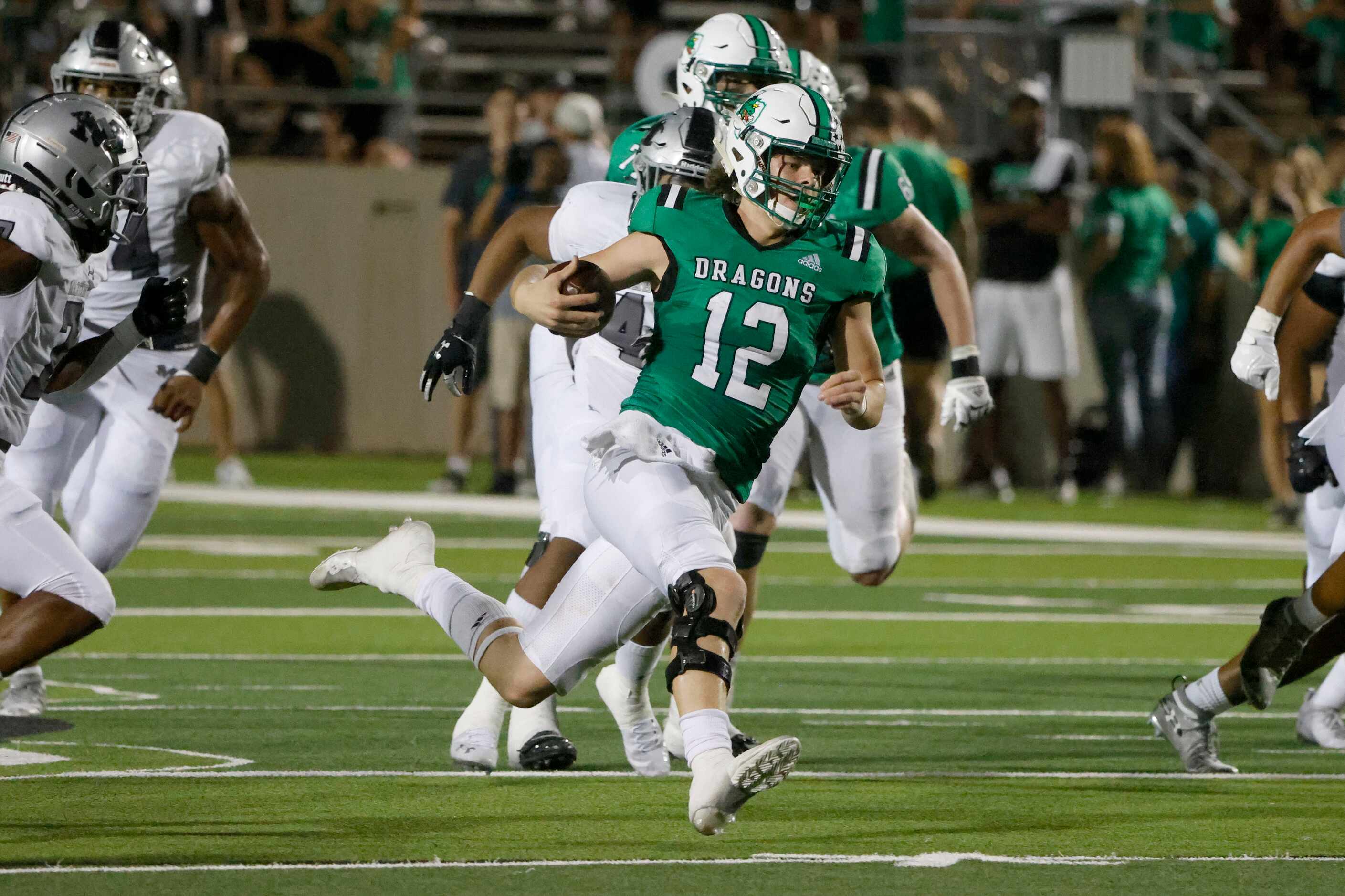 Southlake Carroll quarterback Kaden Anderson (12) scrambles for yards against Arlington...