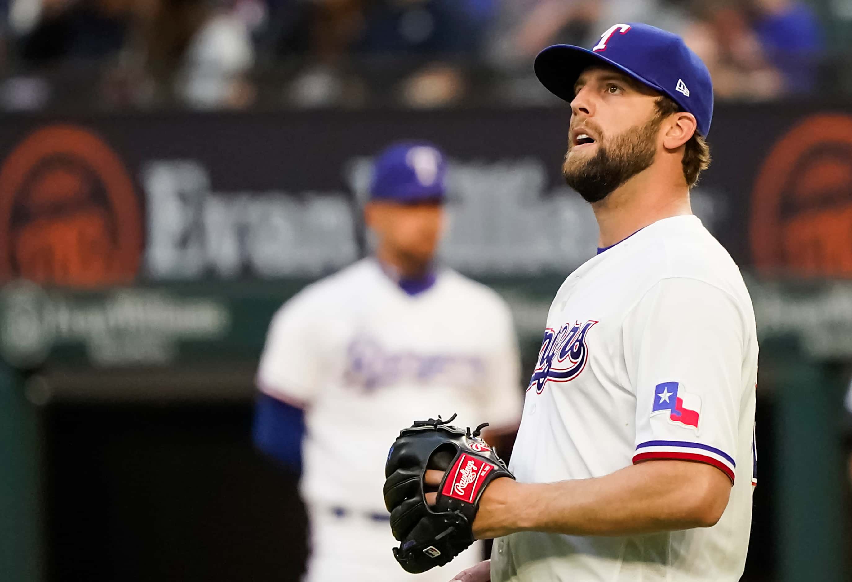 Texas Rangers pitcher Jordan Lyles reacts after a home run by San Diego Padres first baseman...