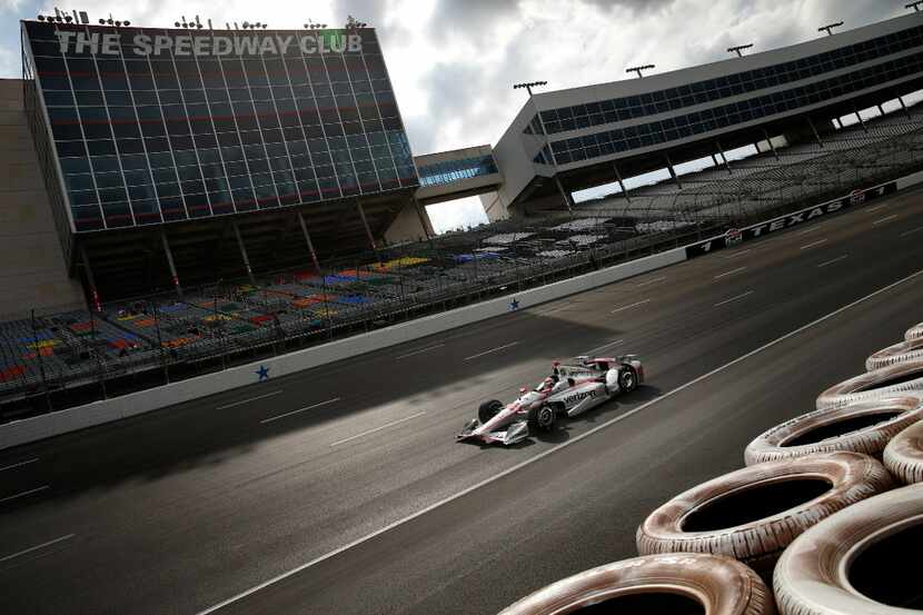 Indy Racing League driver Will Power (12) races through the newly repaved and lowered...