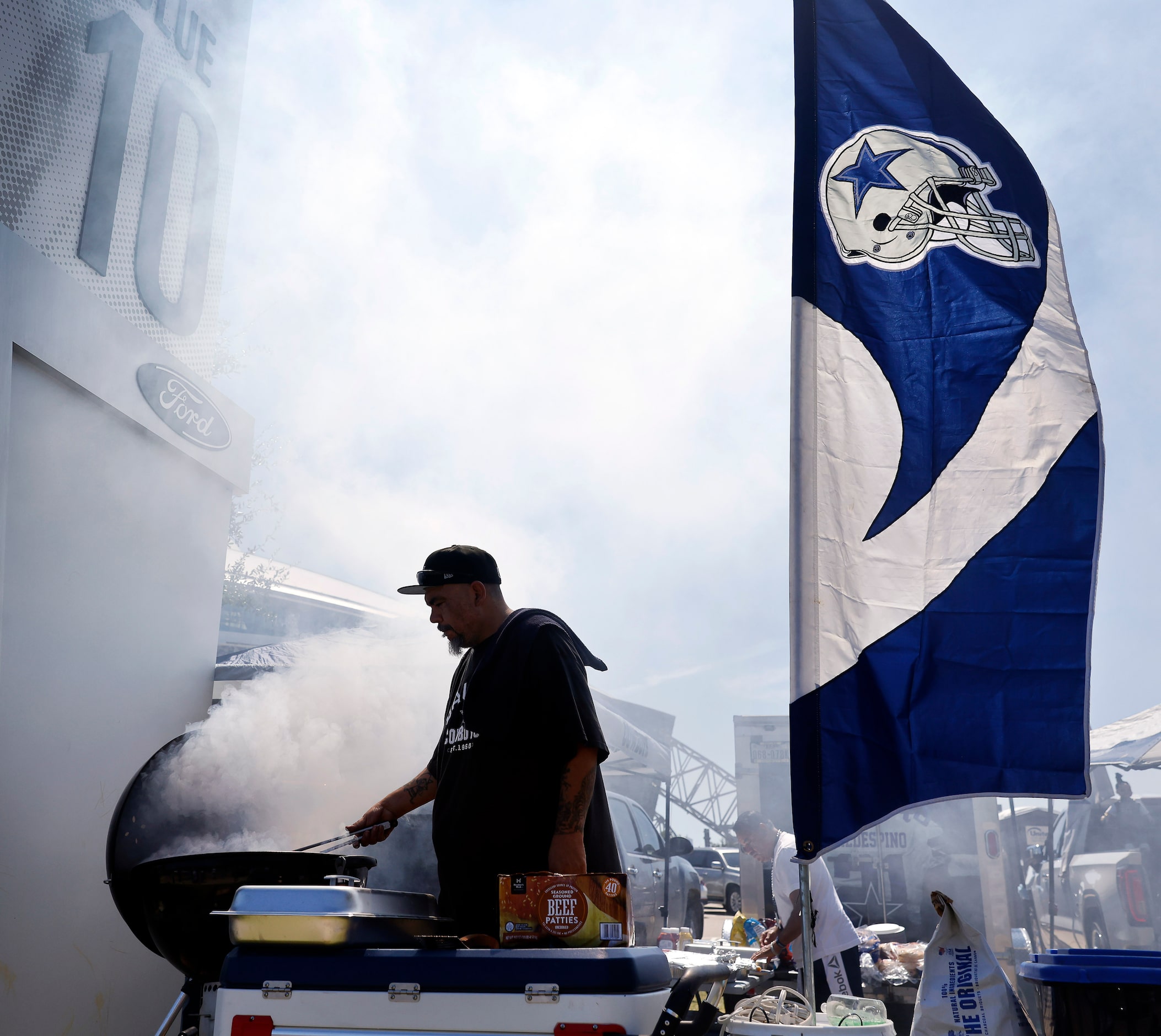 Dallas Cowboys fan Juan Valdez-Vino of Royse City  grills at a tailgate party before their...