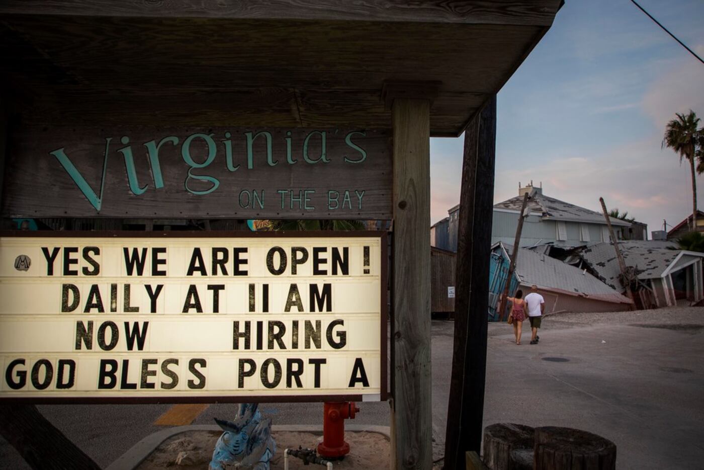 A sign at Virginia's On The Bay restaurant n Port Aransas advertises that the restaurant is...