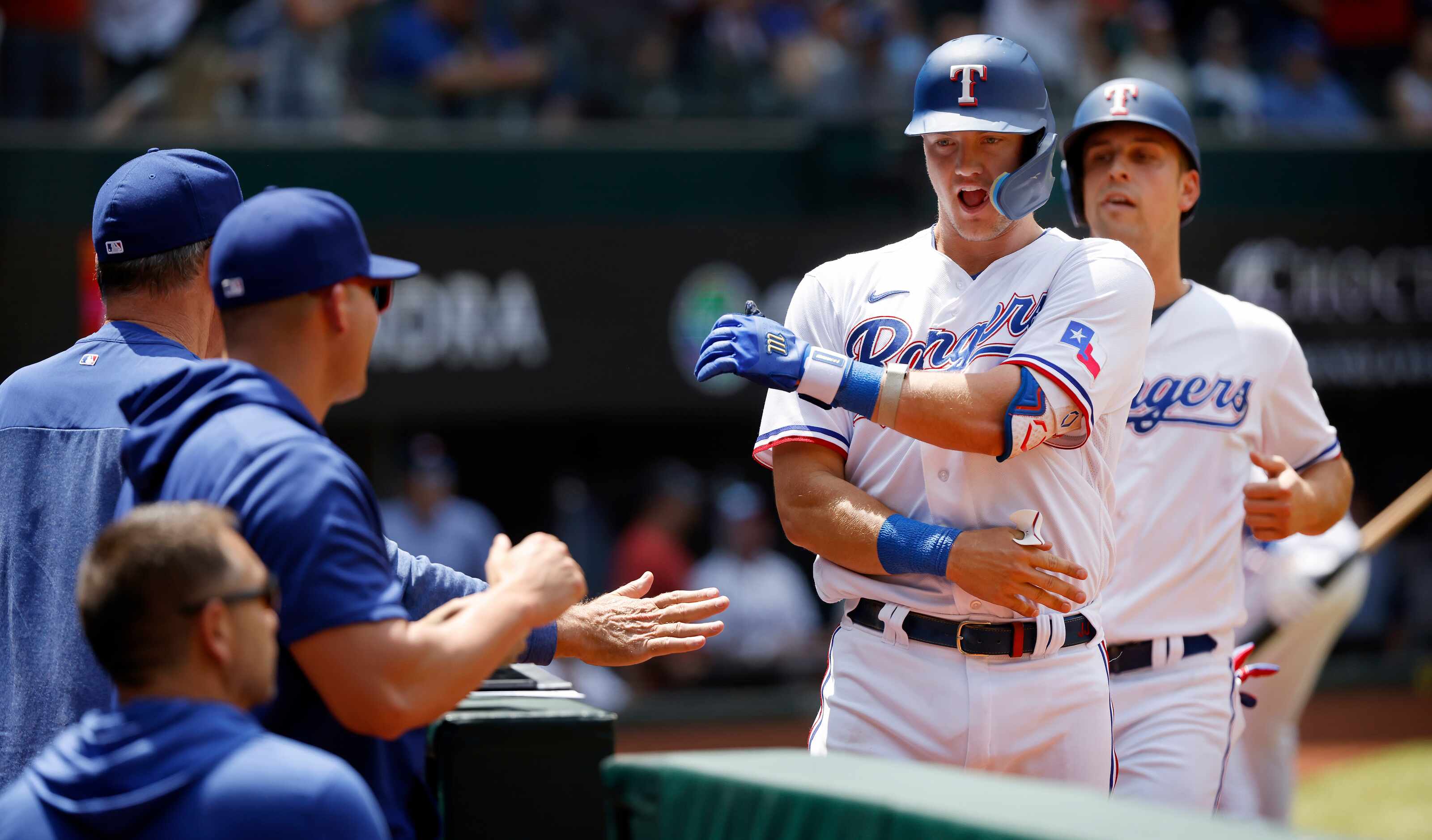 Texas Rangers third baseman Josh Jung (6) celebrates his two-run homer with coaches during...