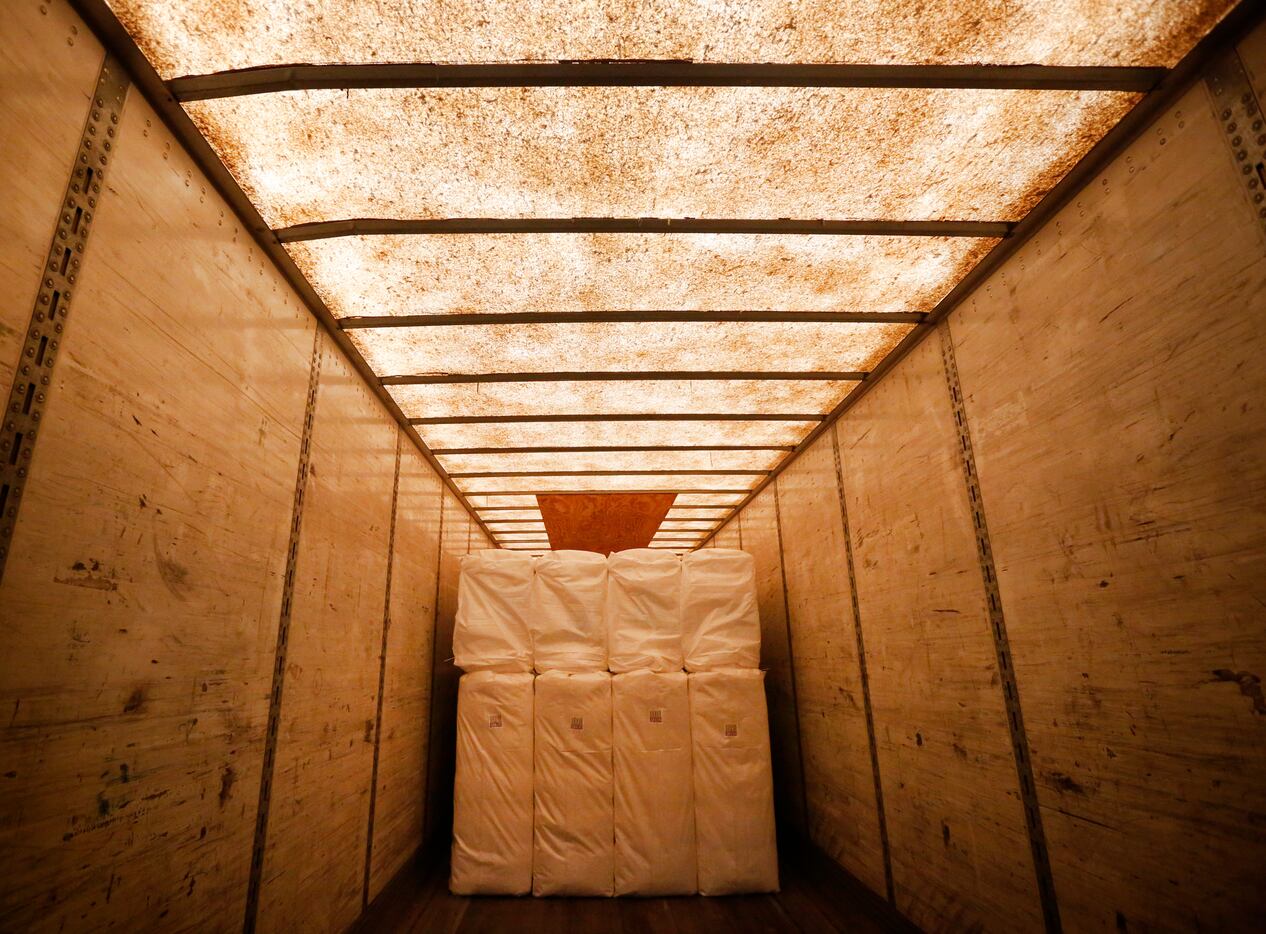 Cotton is placed on a truck after being baled at Adobe Walls Gin, the world's largest gin...