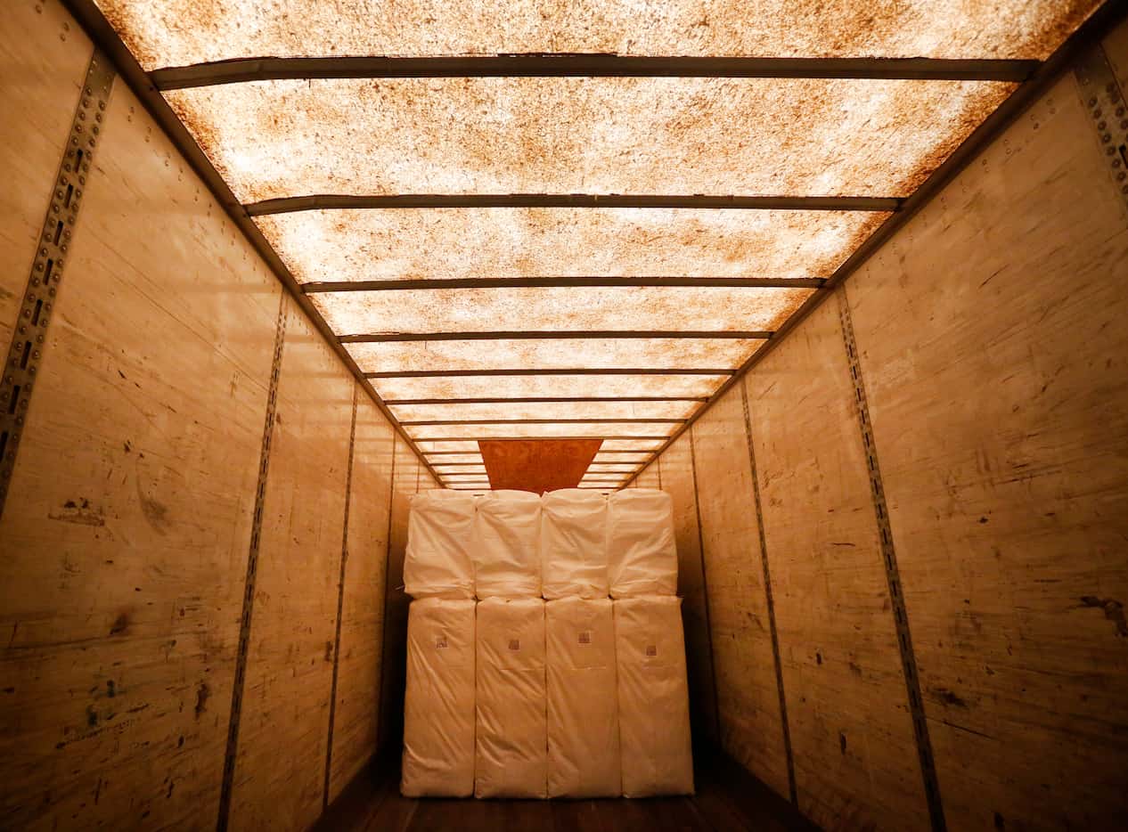 Cotton is placed on a truck after being baled at Adobe Walls Gin, the world's largest gin...