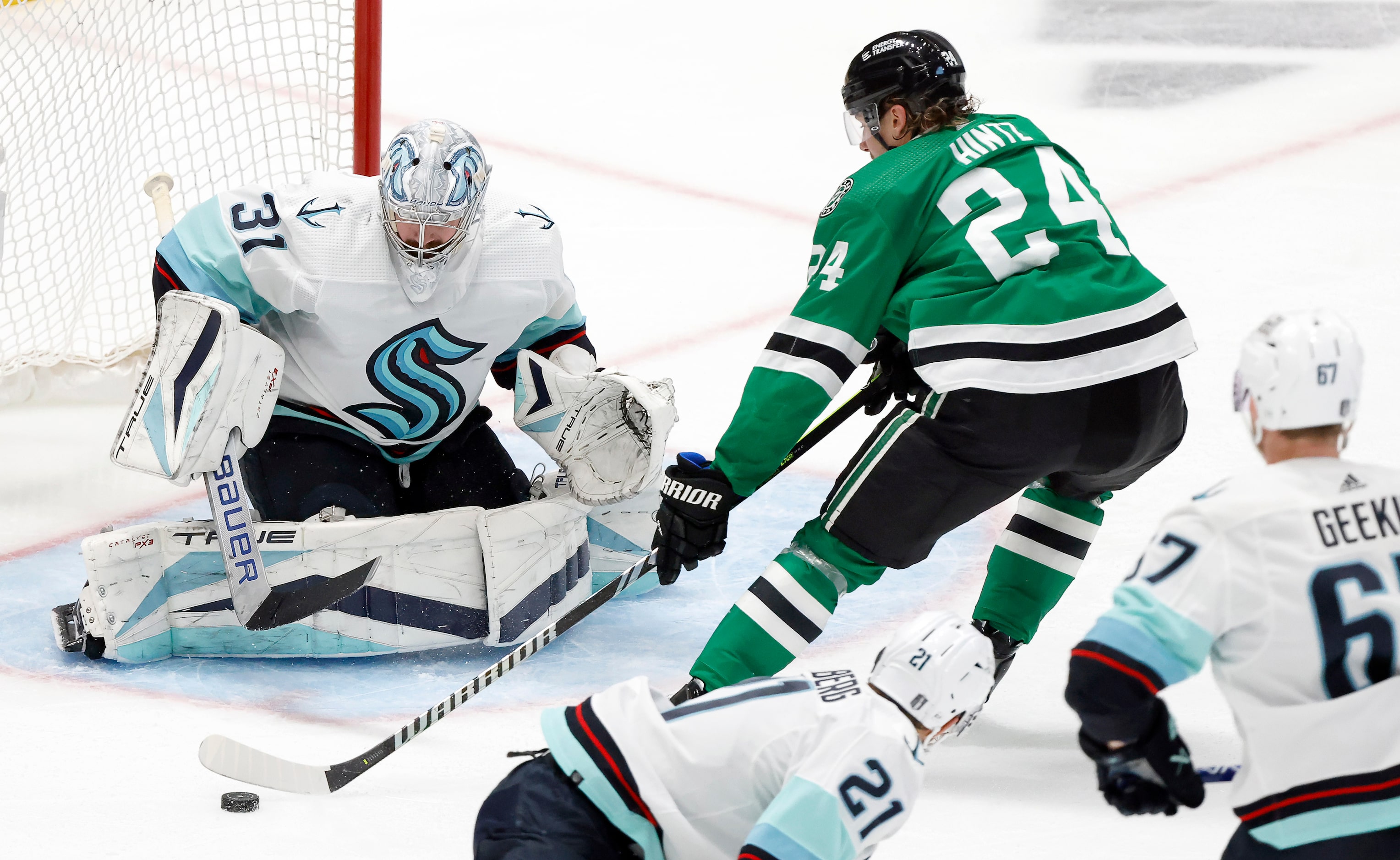 Dallas Stars center Roope Hintz (24) attempts to shoot the rebound on Seattle Kraken...