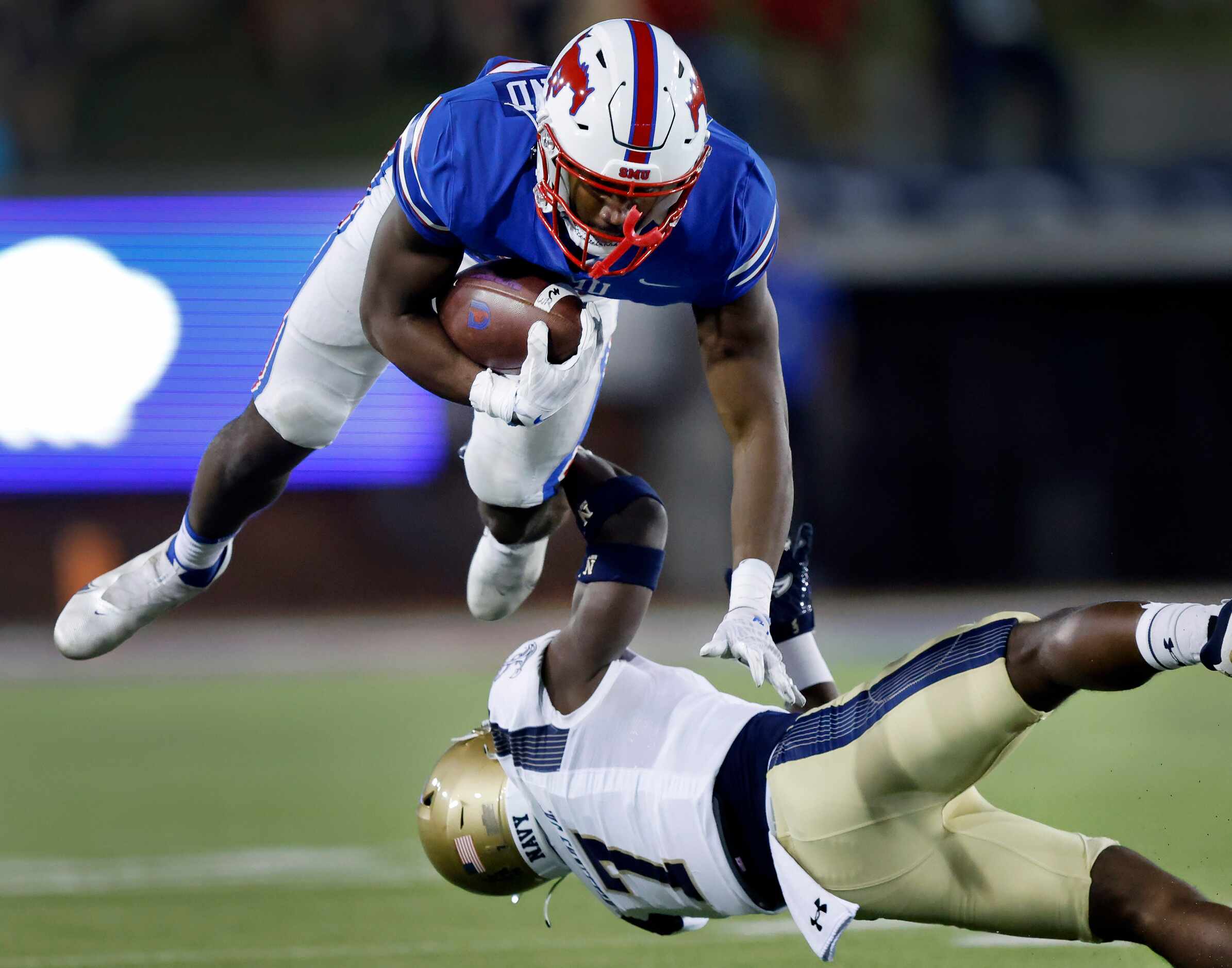 Southern Methodist Mustangs tight end RJ Maryland (82) leaps over the outstretched tackle by...