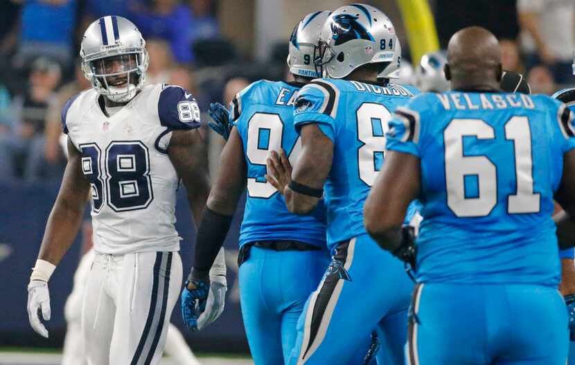 Dallas Cowboys wide receiver Dez Bryant (88) has some words for the Panthers bench in the...