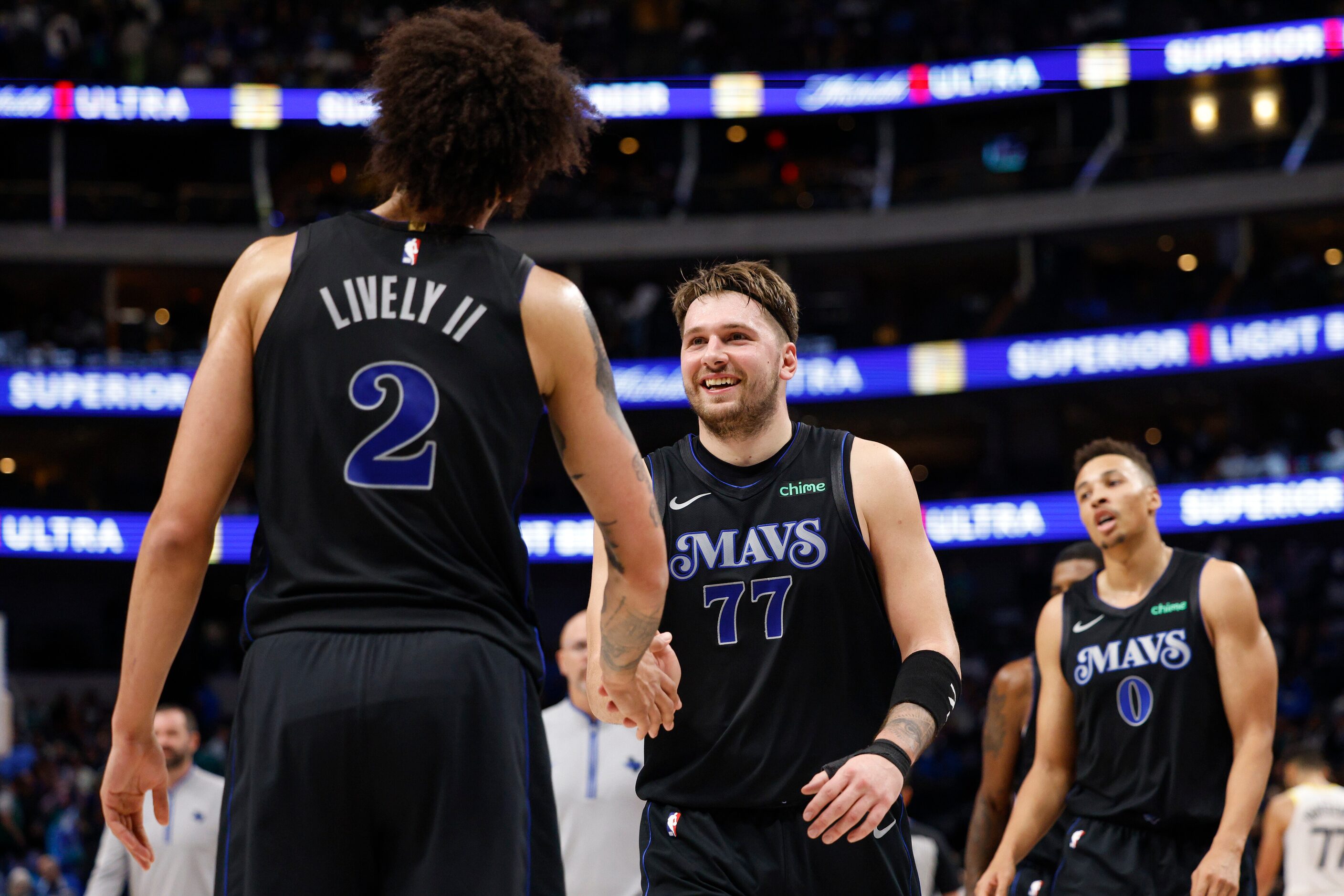 Dallas Mavericks guard Luka Doncic (77) high-fives center Dereck Lively II (2) after the...