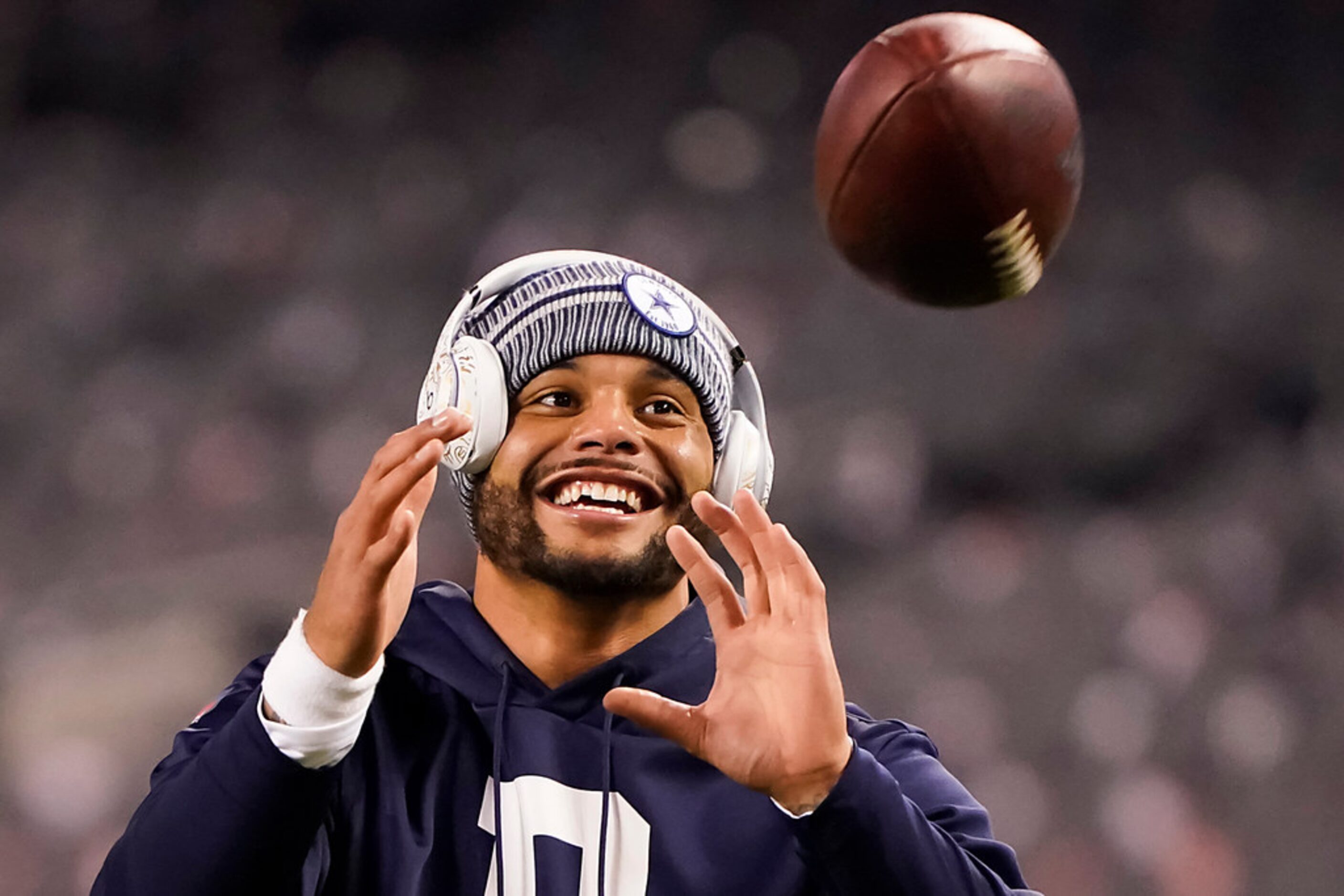 Dallas Cowboys quarterback Dak Prescott warms up before an NFL football game against the...