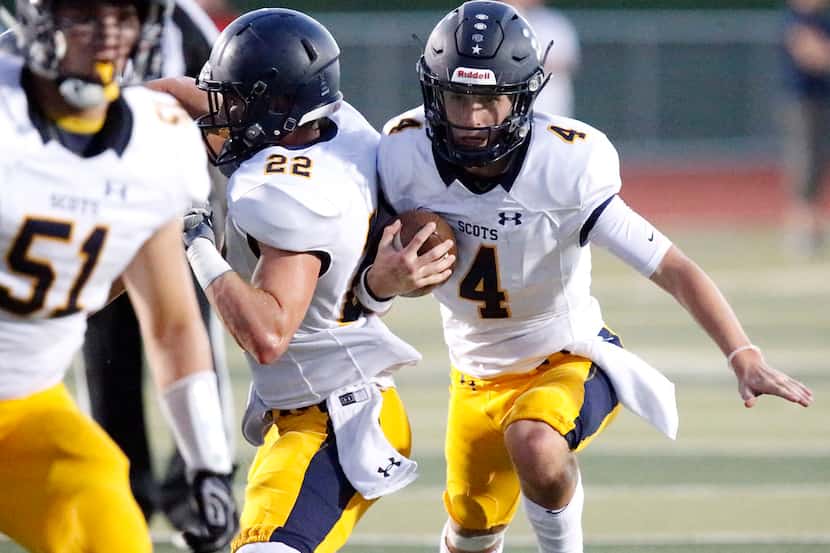 Highland Park High School quarterback Chandler Morris (4) looks for room to run during the...